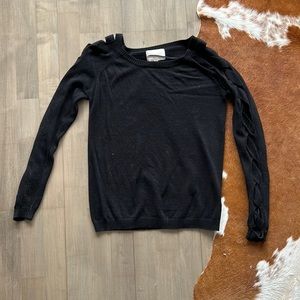 Black “Skies Are Blue” XS sweater with braided pattern on both sleeves.